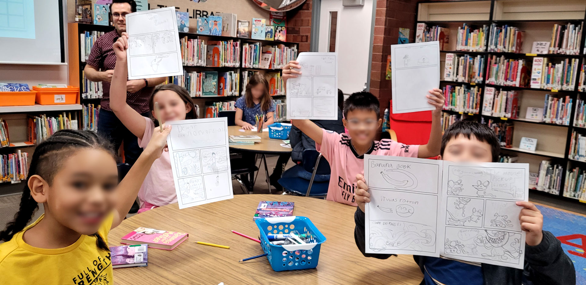 A classroom of happy students showing off their comics